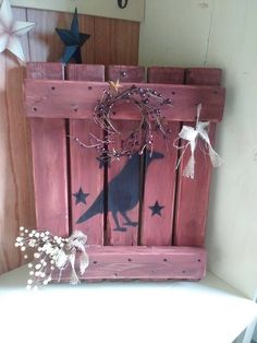 a bird is sitting on top of a bathtub in a bathroom decorated with stars and wreaths