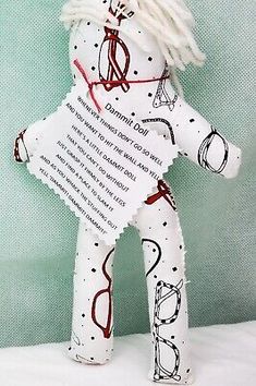 a white teddy bear with red writing on it