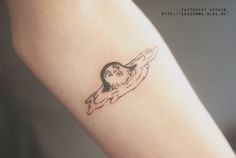 a woman's arm with a small tattoo of a girl on the left side