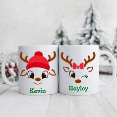 two white coffee mugs with reindeer faces on them