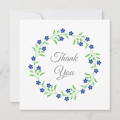 a thank card with blue flowers and green leaves in the center on a white background