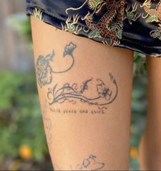 a woman's legs with tattoos and writing on them