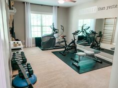 there is a gym with exercise equipment in the room, and mirrors on the wall