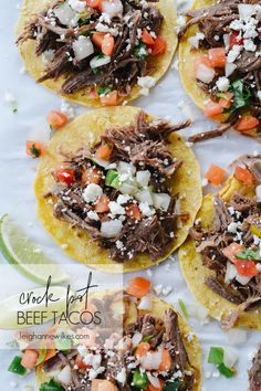 four shredded beef tacos on corn tortillas