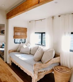 a couch sitting in the middle of a living room next to a wooden counter top