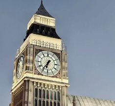 a large clock tower on top of a building with sky in the backround