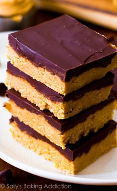 a stack of cake sitting on top of a white plate next to some chocolate chips