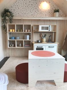 a small kitchen with an oven, microwave and stools