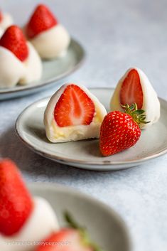 two plates with strawberries on top of them