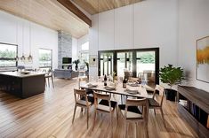 a large dining room with wooden floors and white walls, along with an open floor plan