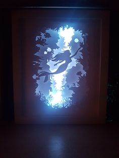 an illuminated piece of artwork in a dark room