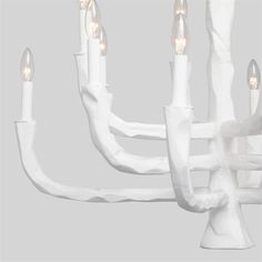 a white chandelier with five candles in it