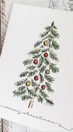 a christmas card with an image of a pine tree