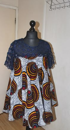 This is a  vibrant handmade short flared dress with lace detail. This dress has pockets - stylish and practical, perfect for all  occasions.  Currently available in two sizes. Size: UK10 Size: 14 - 16UK Feel free to send me a message if you have any questions. Ankara Flared Dress Styles, Short Flay Gown Styles With Material, Short Flare Dress Ankara, Ankara Free Gown Styles For Women Short, Free Short Ankara Gown Styles, Lace Short Dress Styles, Ankara Free Short Gown Styles, Ankara Flare Dresses Short, Free Gown Styles For Women