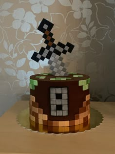 a cake made to look like an old school video game character with a pixel on top