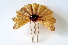 "Beautiful large vintage hair comb is fan shaped with jewels. Art Deco fan shaped hair comb is designed by French designer Jules Van Rouge. There are 9 filigreed gold cone shapes with curved edges interspersed with 8 rows of rhinestones set in prongs, and a large amber  colored faux stone. Four prongs are for holding in place. Very ornate, detailed, and beautifully designed . A one of a kind show piece. Excellent vintage condition with a very small minor scuff on jewel. Measures 7 1/2\"W x 7 1/3 Jeweled Hair Accessories, Vintage Hair Comb, Decorative Hair Combs, Art Deco Hair, Art Deco Fan, Vintage Hair Combs, Tiara Hairstyles, Art Deco Patterns, French Designer