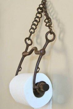 a roll of toilet paper hanging from a chain