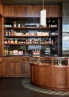 a kitchen filled with lots of wooden shelves