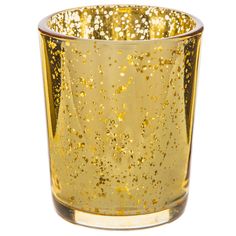 a gold colored glass filled with lots of golden flecks on the inside of it