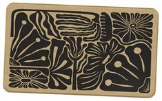 a wooden cutting board with black and white designs