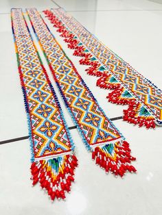 two rows of beaded necklaces on the floor