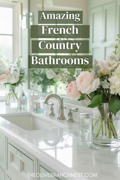 a white bathroom sink sitting under a window next to a vase with flowers in it