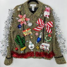 an ugly sweater is adorned with christmas decorations and tinsel on the bottom, along with other holiday items