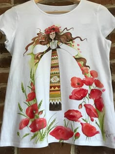 a white t - shirt with an image of a woman and flowers on the front