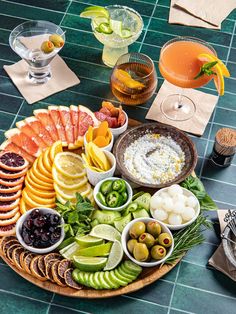 a platter filled with assorted fruits and veggies on top of a table