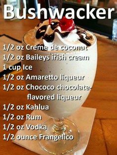 an ice cream sundae with toppings is shown on a wooden counter top in front of a bar