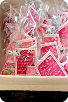 a box filled with lots of pink and white tags