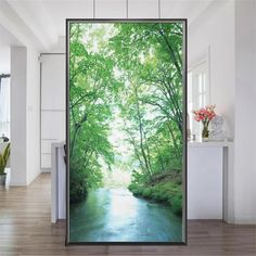 an open door with the view of a river and trees in the woods on it