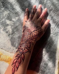 a woman's hand with tattoos on it