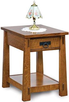 a small wooden table with a lamp on top and one drawer open to show the contents