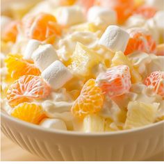 a white bowl filled with fruit and marshmallows