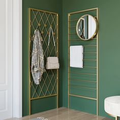 a bathroom with green walls and gold metal racks holding towels, toiletries and other items