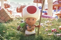 a small toy is standing in the grass with a mushroom on it's head