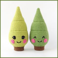 two crocheted green and pink pears sitting next to each other