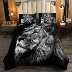 a black and white photo of a lion on a bed with two pillows in front of it