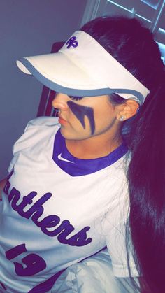 a woman with her face painted like a baseball player