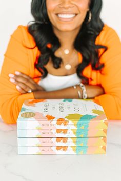 a woman sitting in front of three books