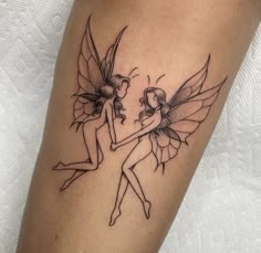 a couple of fairy tattoos on the leg