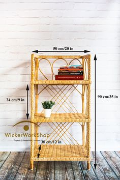 a wicker shelf with books on it against a white brick wall and wooden floor