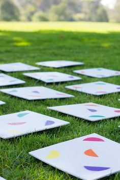 a group of white tiles sitting on top of a lush green field