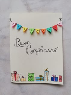 a handmade greeting card for someone's birthday with presents and bunting flags