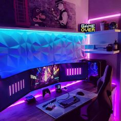 a computer desk topped with two monitors and a keyboard next to a neon lit wall