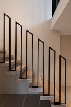 a set of stairs leading up to a second floor with railings on each side