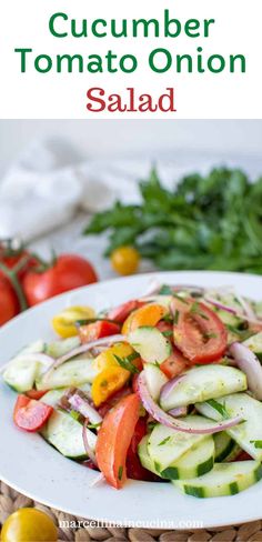 cucumber tomato onion salad on a white plate