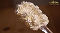 a close up of a spoon with whipped cream on it