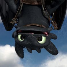 a close up of a dragon flying in the sky